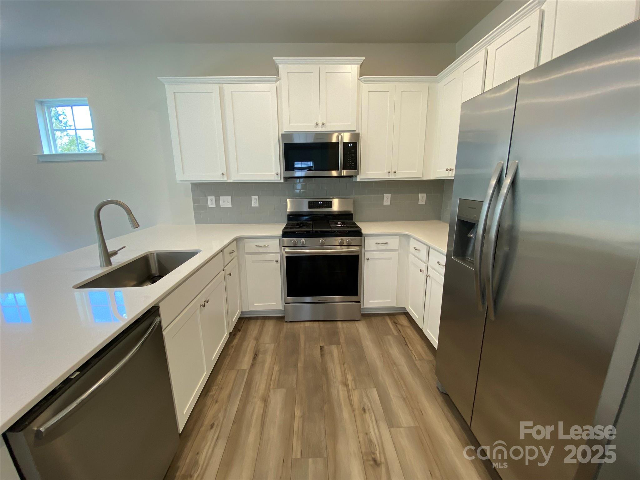 18219 Stark Way Charlotte, NC 28278 - Photo 3 of 42 a kitchen with a sink stove and refrigerator