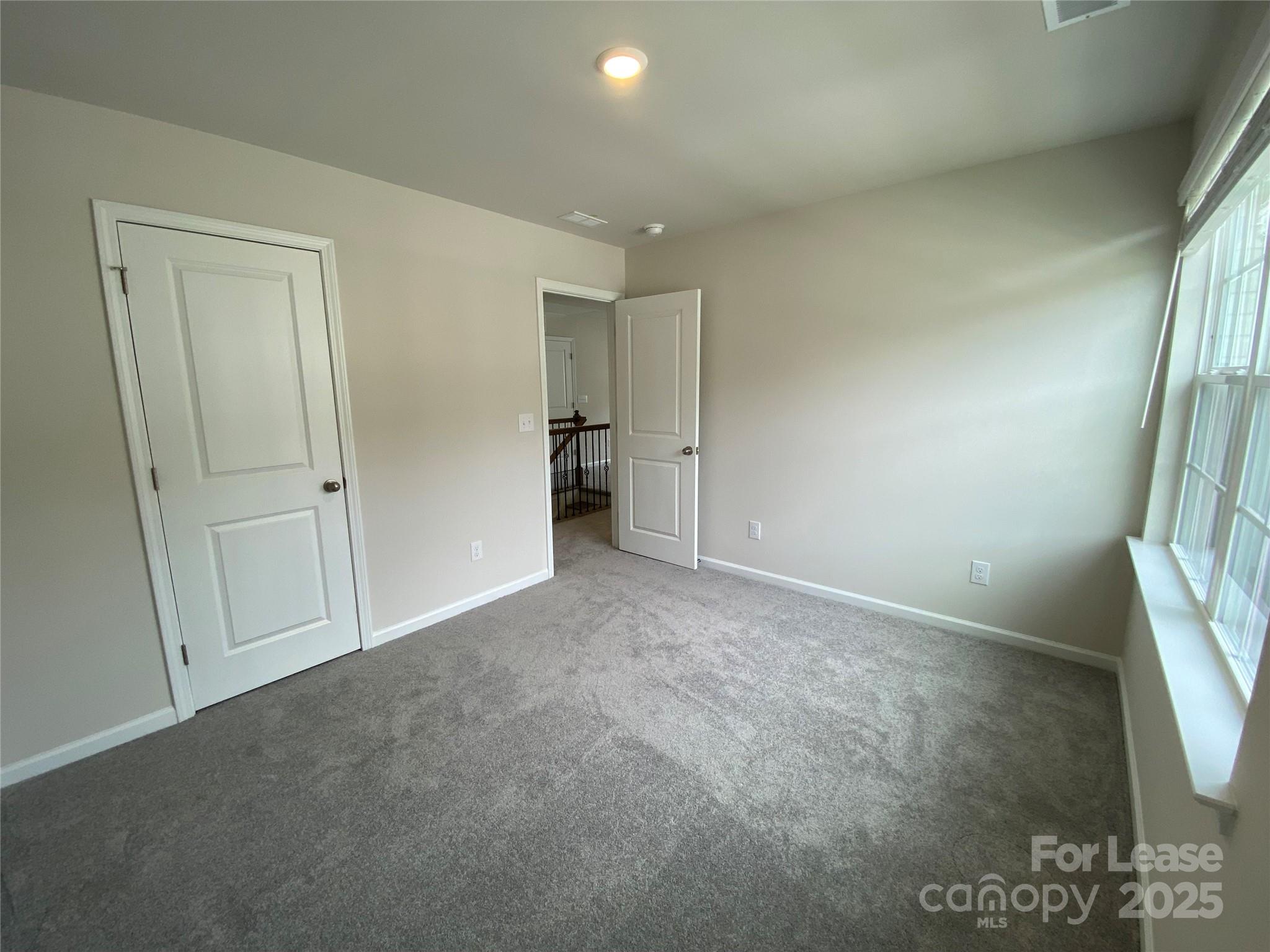 18219 Stark Way Charlotte, NC 28278 - Photo 33 of 42 an empty room with windows and closet