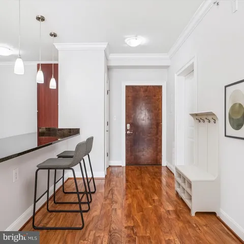 a view of a room with furniture and wooden floor