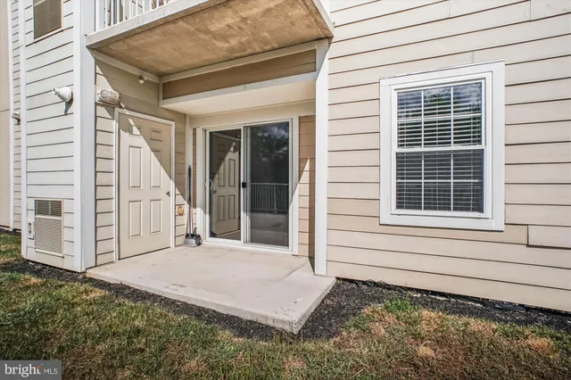 a view of a house with window and wooden fence
