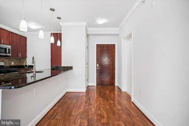 a view of a kitchen with a sink and microwave