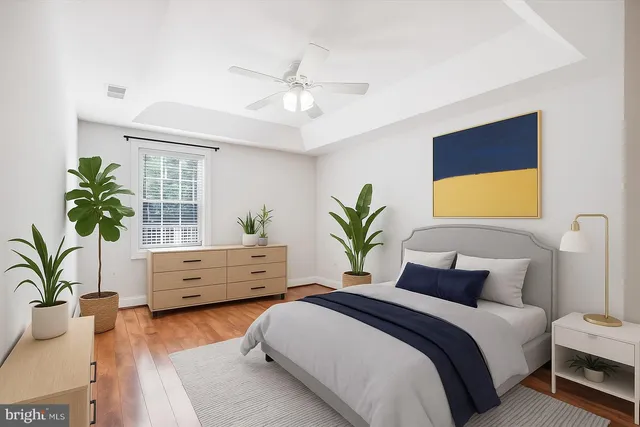 a bedroom with a bed and a potted plant
