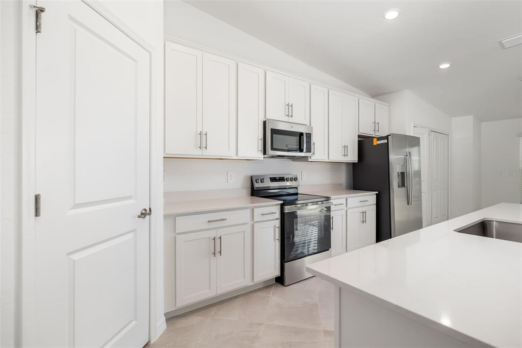 19015 Scallop Loop, Unit 204 Lakewood Ranch, FL 34211 - Photo 11 of 56 a kitchen with a refrigerator stove and sink