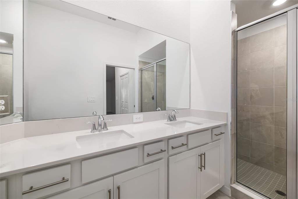 19015 Scallop Loop, Unit 204 Lakewood Ranch, FL 34211 - Photo 28 of 56 a bathroom with a sink and a mirror