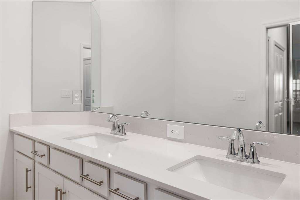 19015 Scallop Loop, Unit 204 Lakewood Ranch, FL 34211 - Photo 29 of 56 a bathroom with a sink and a mirror