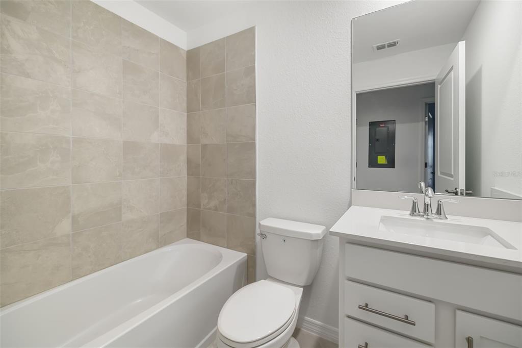 19015 Scallop Loop, Unit 204 Lakewood Ranch, FL 34211 - Photo 32 of 56 a bathroom with a toilet a sink and bathtub