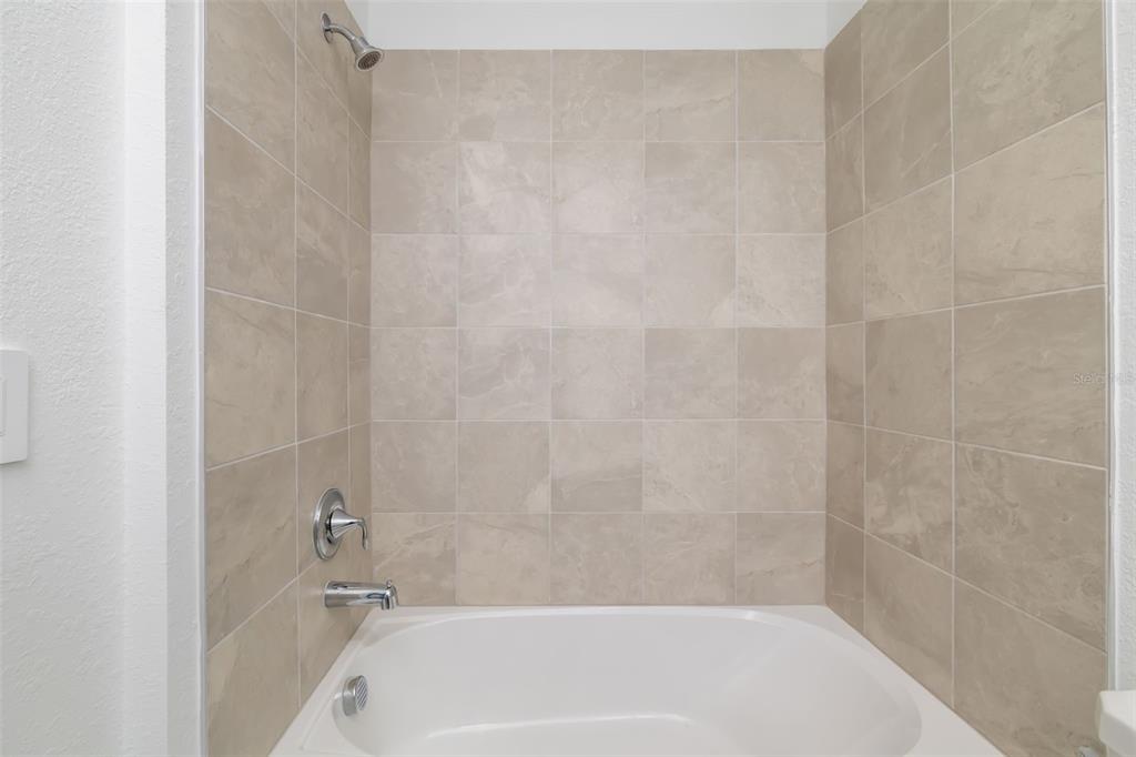 19015 Scallop Loop, Unit 204 Lakewood Ranch, FL 34211 - Photo 33 of 56 a bathroom with a shower and a bath tub