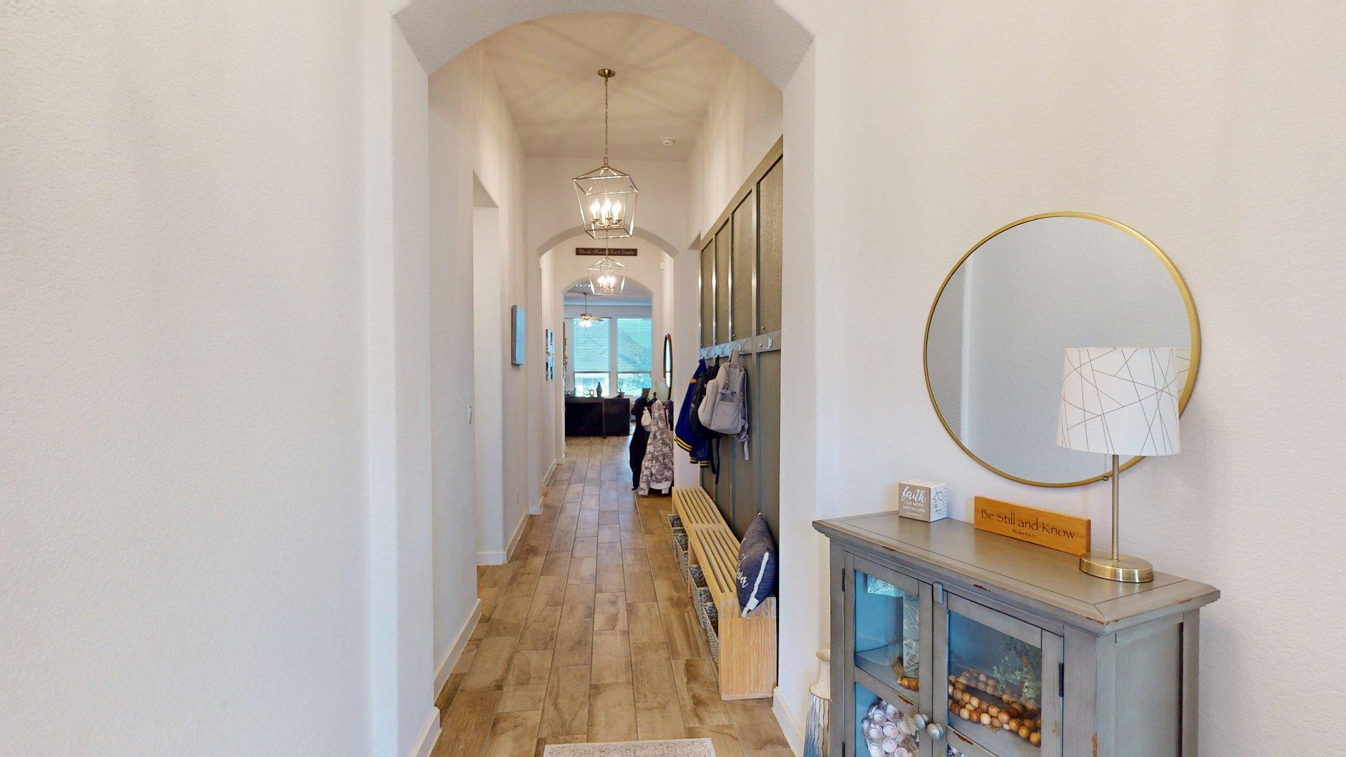 244 Heartleaf Road San Marcos, TX 78666 - Photo 4 of 26 an entryway with wooden floor and a hallway