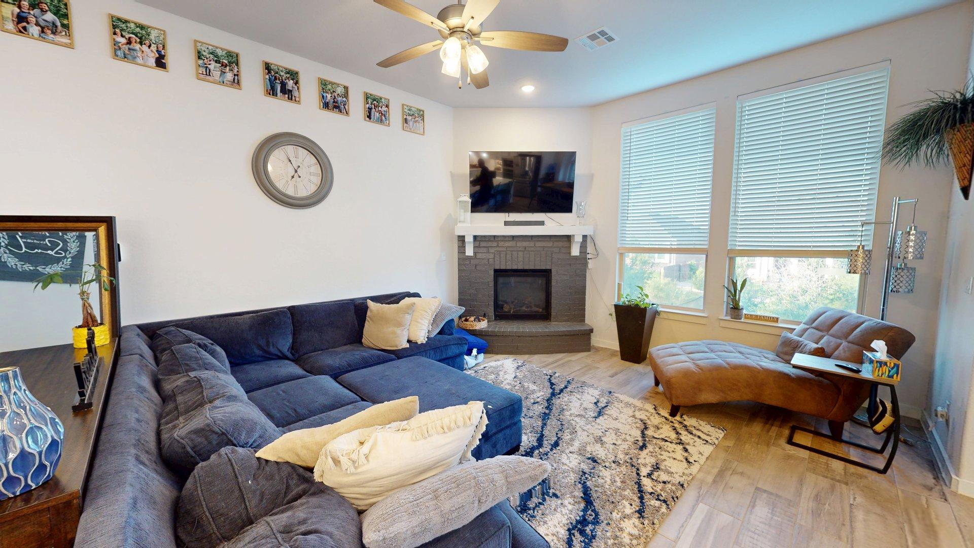 244 Heartleaf Road San Marcos, TX 78666 - Photo 5 of 26 a living room with furniture a fireplace and a flat screen tv