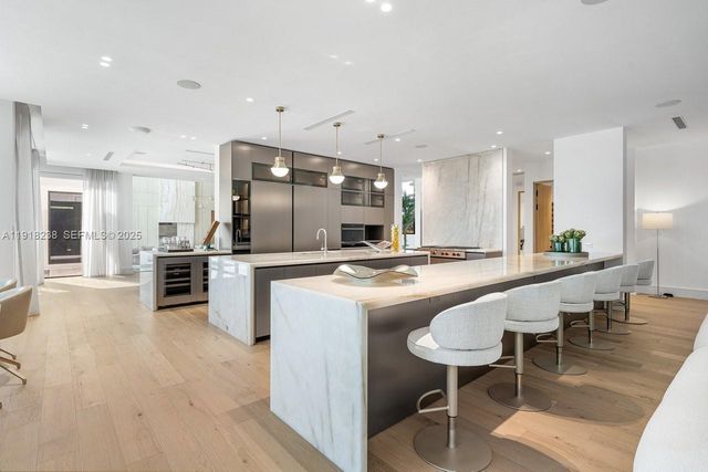 a living room with furniture a rug and a large window