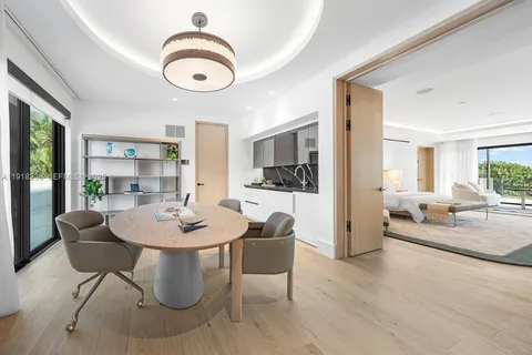 a white bath tub sitting in a room next to a large window