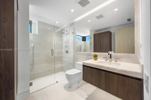 a palm tree sitting in front of a house with a yard