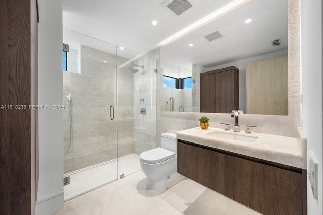 a palm tree sitting in front of a house with a yard