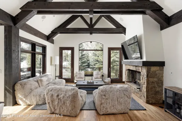 a living room with furniture fireplace and flat screen tv