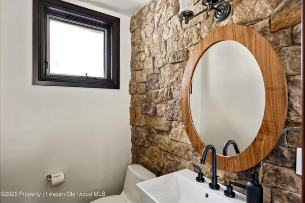 a bathroom with a sink mirror and toilet