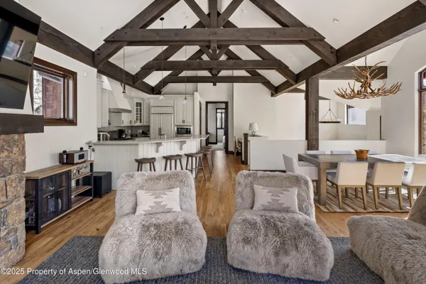a living room with lots of furniture and kitchen view