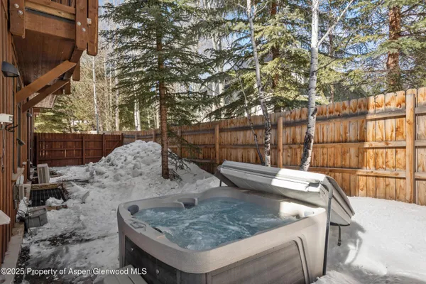 a view of a backyard with jacuzzi
