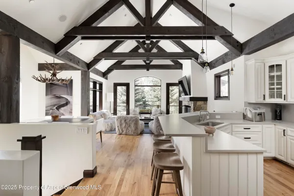 a view of a dining room with furniture wooden floor and chandelier