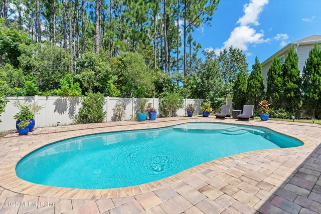 a view of a swimming pool with lawn chairs