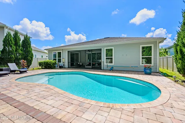 a view of a house with swimming pool and porch