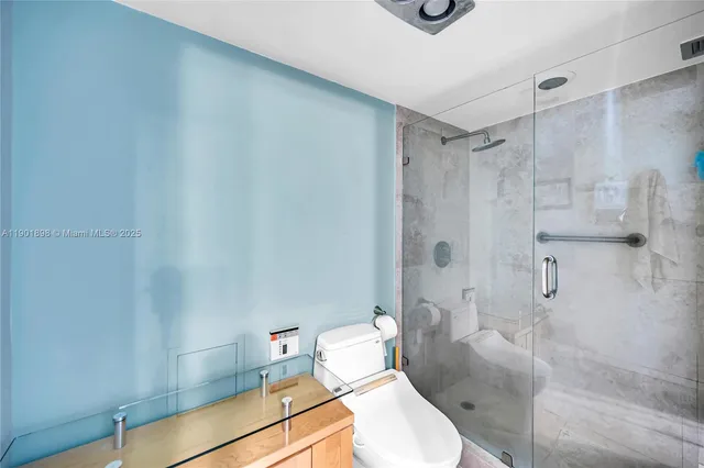 a bedroom with a bed furniture and a large window