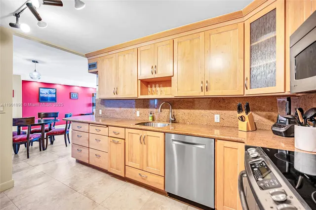 a living room with stainless steel appliances kitchen island granite countertop furniture and a kitchen view