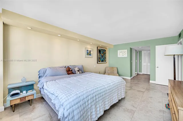 a bedroom with a bed and a night stand