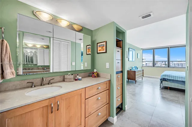 a living room with furniture kitchen view and large windows