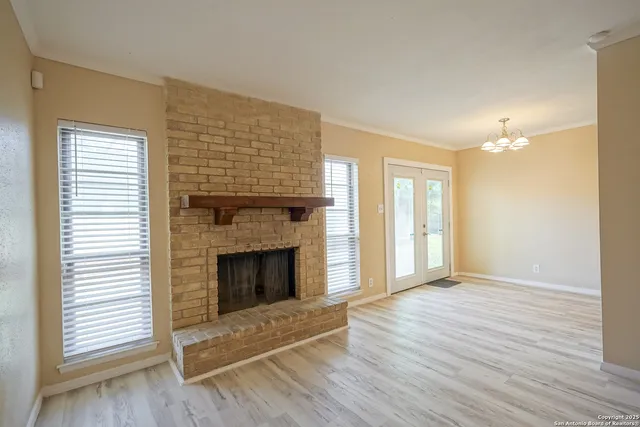 a view of kitchen with sink and refrigerator