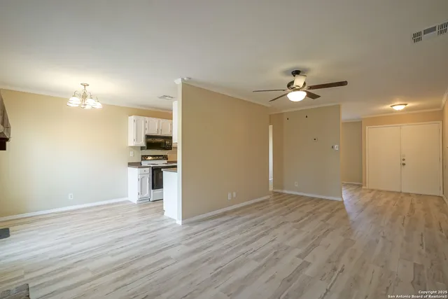 a kitchen with granite countertop a stove and a refrigerator