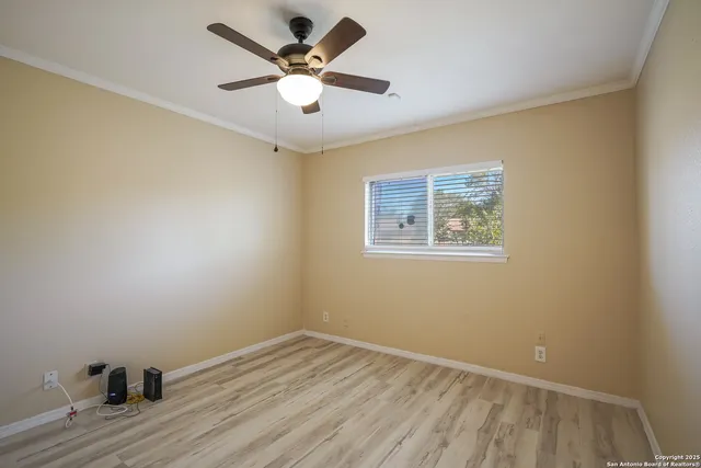a view of a room with wooden floor and white walls