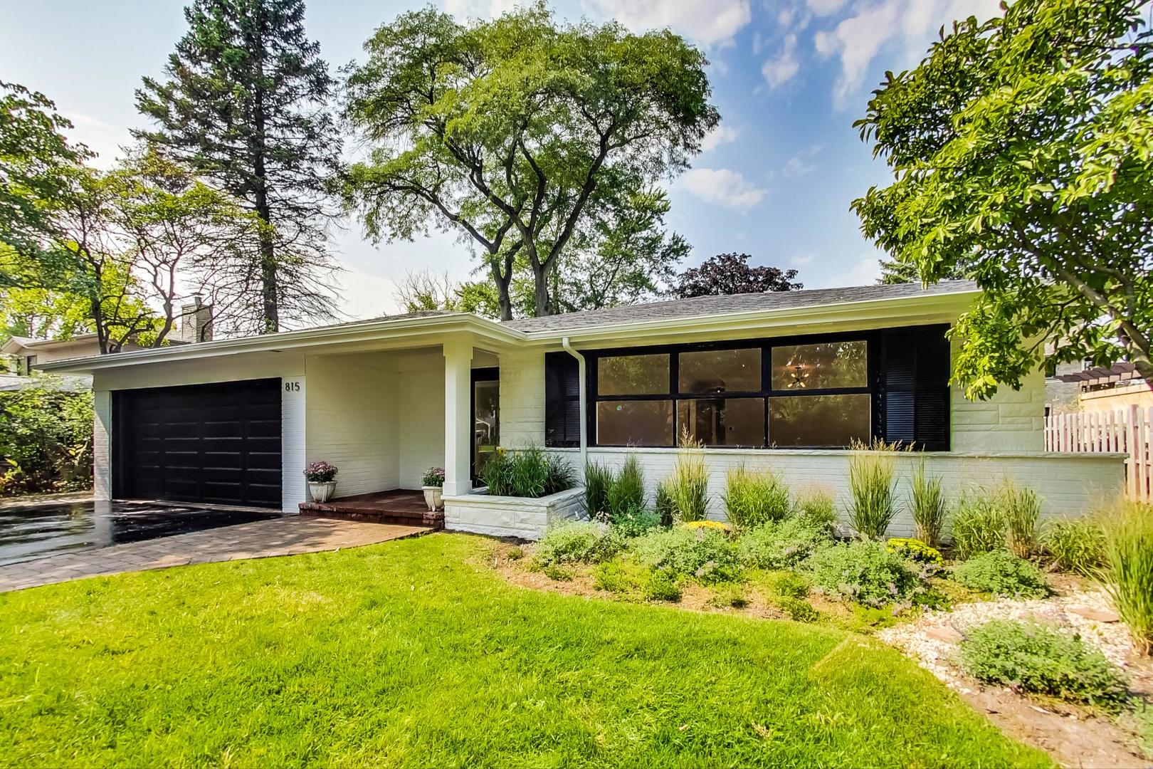 815 Locust Road Wilmette, IL 60091 - Photo 1 of 23 a front view of a house with a yard and garage