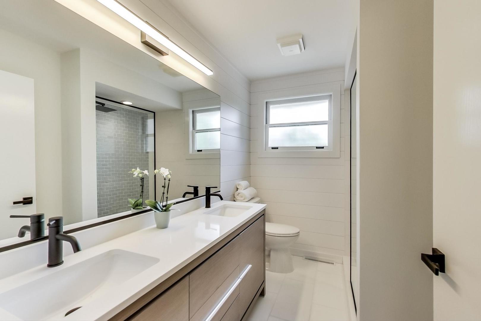 815 Locust Road Wilmette, IL 60091 - Photo 11 of 23 a bathroom with a sink and a mirror