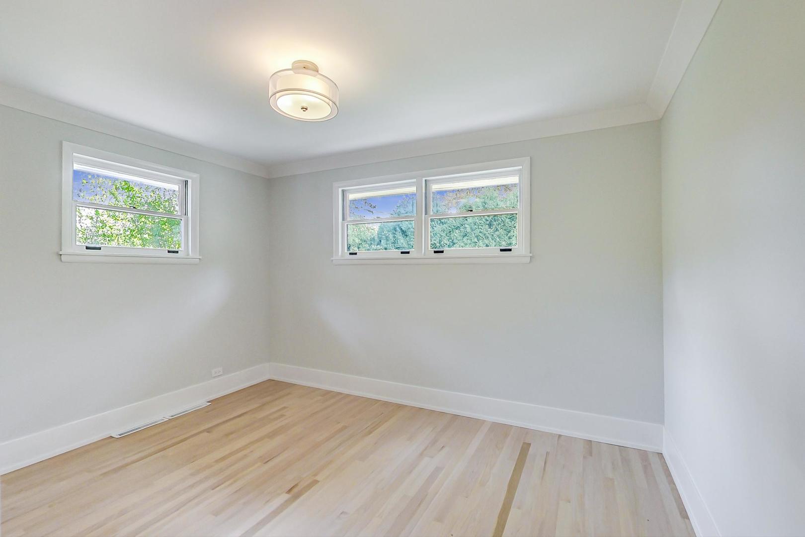 815 Locust Road Wilmette, IL 60091 - Photo 12 of 23 an empty room with wooden floor and windows