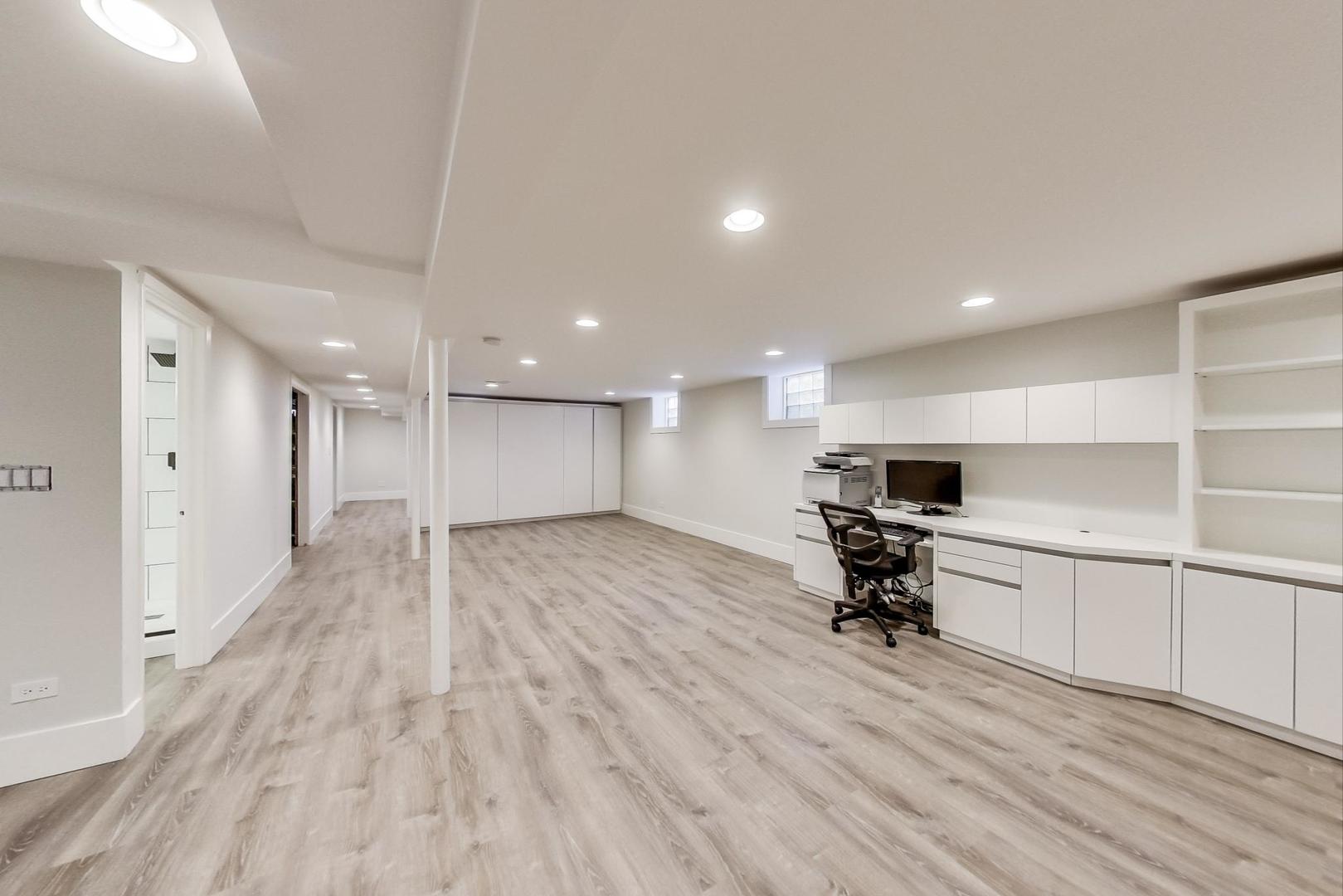 815 Locust Road Wilmette, IL 60091 - Photo 15 of 23 a view of a kitchen with kitchen island a sink wooden floor and stainless steel appliances