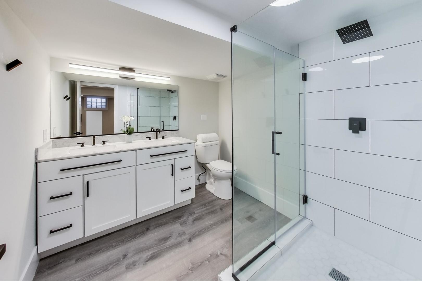 815 Locust Road Wilmette, IL 60091 - Photo 17 of 23 a spacious bathroom with a double vanity sink a mirror and shower