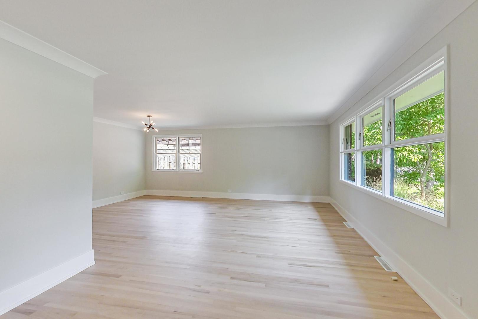 815 Locust Road Wilmette, IL 60091 - Photo 3 of 23 a view of an empty room with wooden floor and a window