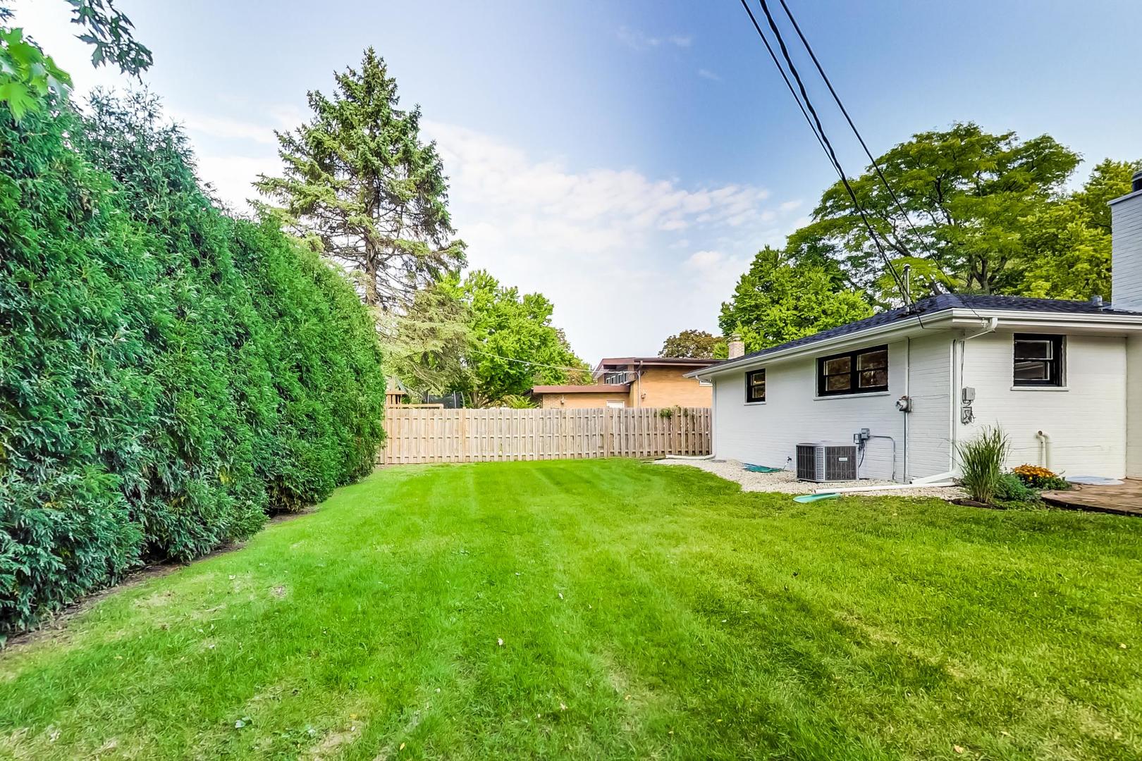815 Locust Road Wilmette, IL 60091 - Photo 21 of 23 a view of a backyard with plants and large tree