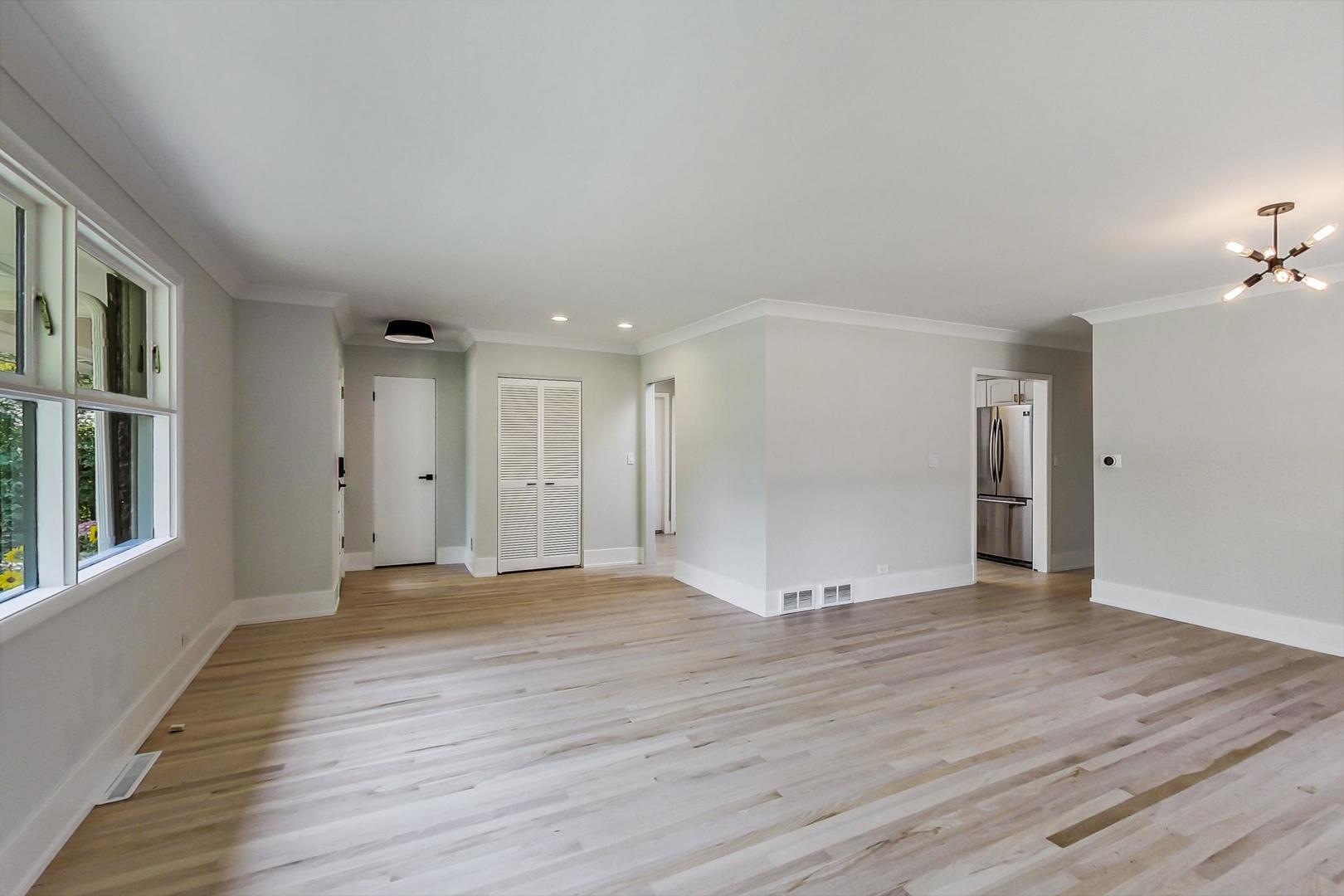 815 Locust Road Wilmette, IL 60091 - Photo 4 of 23 a view of an empty room with wooden floor and a window