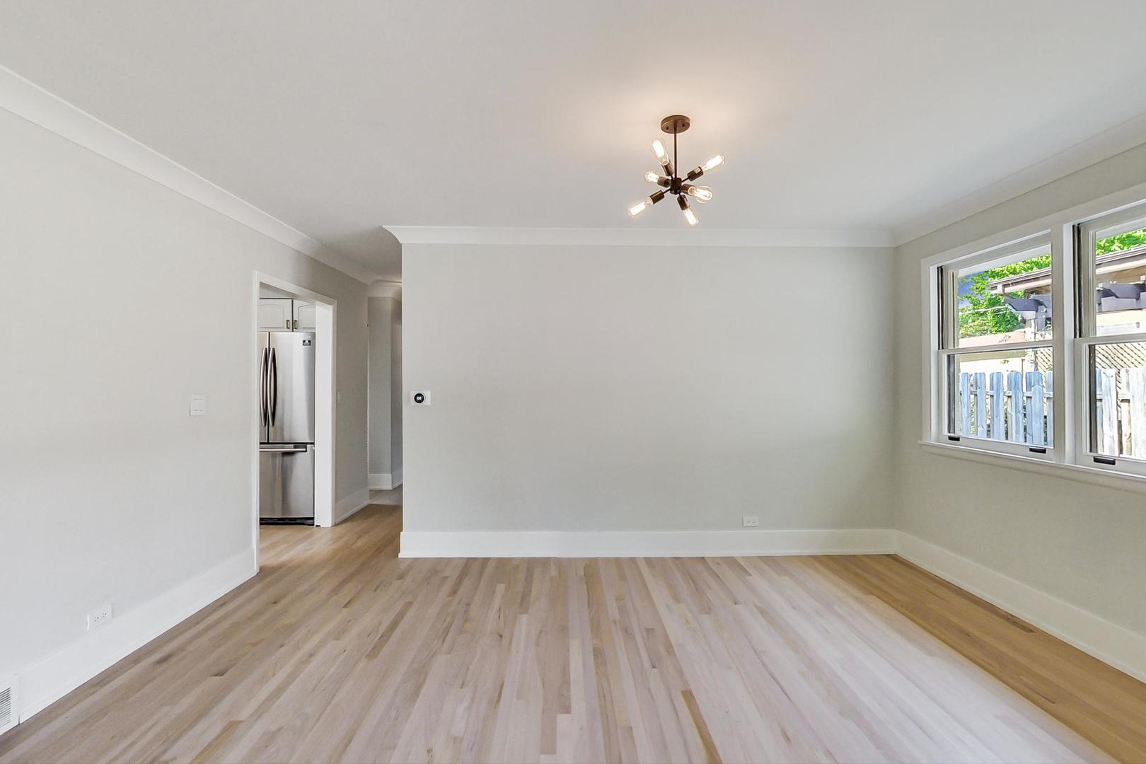 815 Locust Road Wilmette, IL 60091 - Photo 5 of 23 wooden floor in an empty room with a window