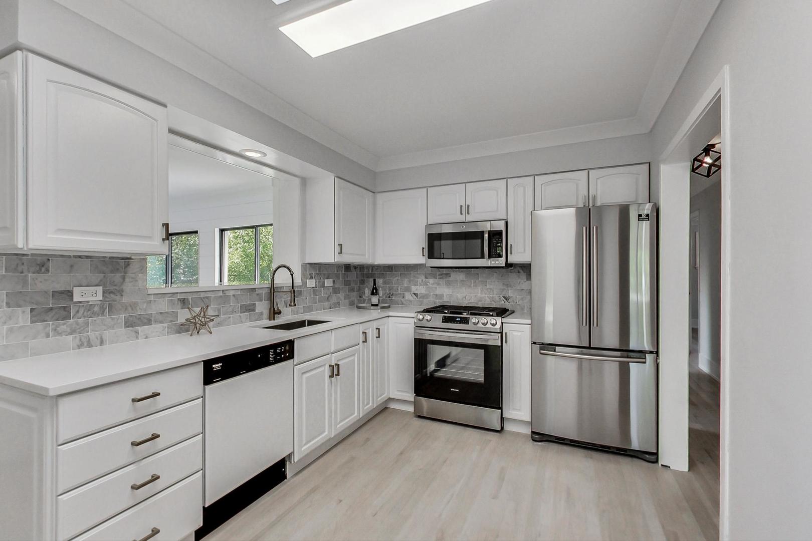 815 Locust Road Wilmette, IL 60091 - Photo 6 of 23 a kitchen with stainless steel appliances granite countertop a refrigerator sink and stove