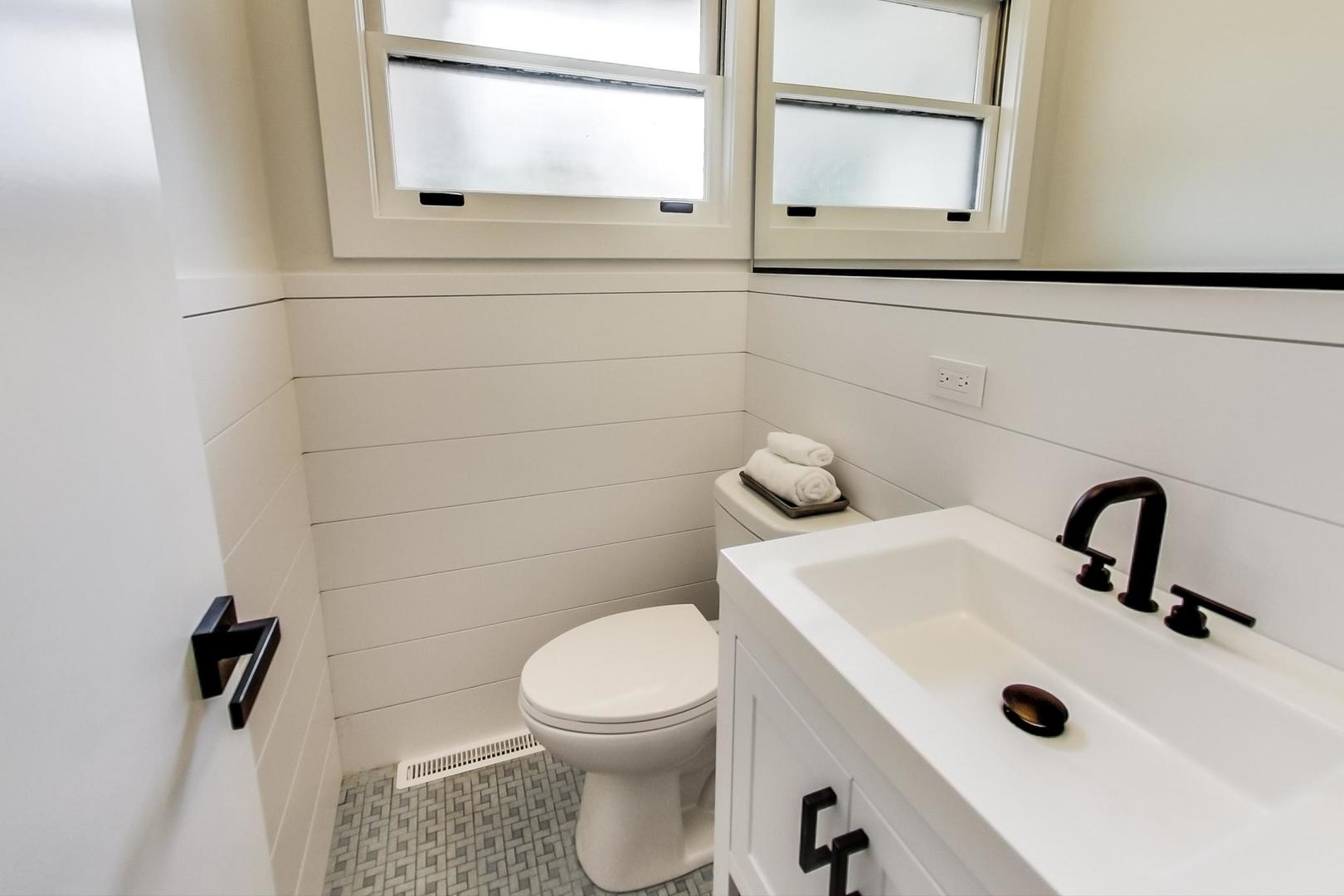 815 Locust Road Wilmette, IL 60091 - Photo 9 of 23 a bathroom with a sink a toilet and mirror