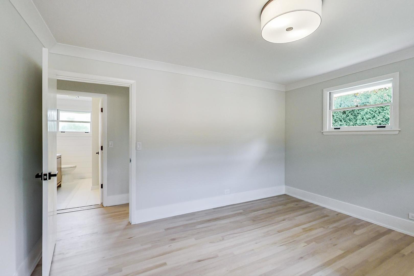 815 Locust Road Wilmette, IL 60091 - Photo 10 of 23 an empty room with wooden floor and window