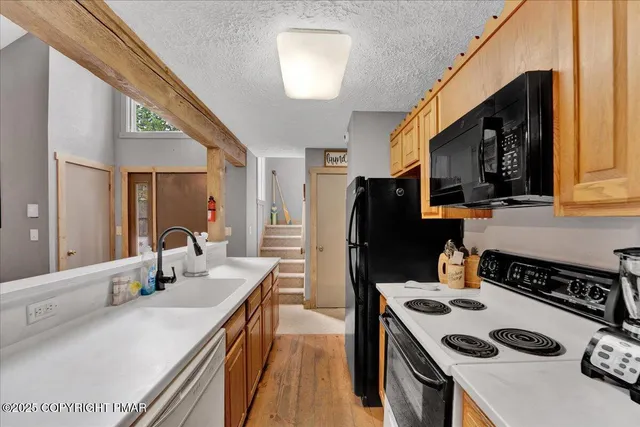 a kitchen with a sink a stove and refrigerator