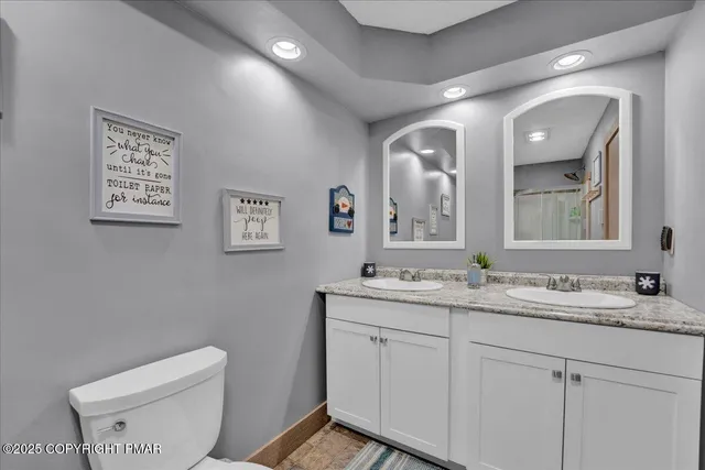 a bathroom with a toilet sink and mirror