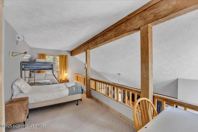 a bedroom with furniture and a window