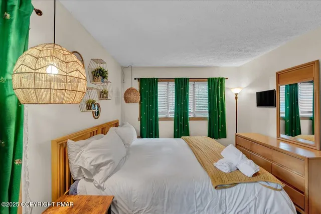 a bedroom with a bed and window