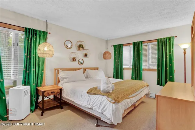 a bedroom with a bed and a large window