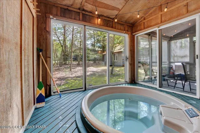 a view of a porch with furniture and wooden floor
