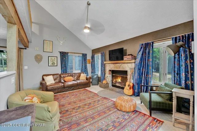 a living room with furniture fireplace and flat screen tv